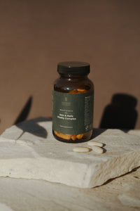 Sanvee skin and nails vitality complex bottle with tablets on stone surface