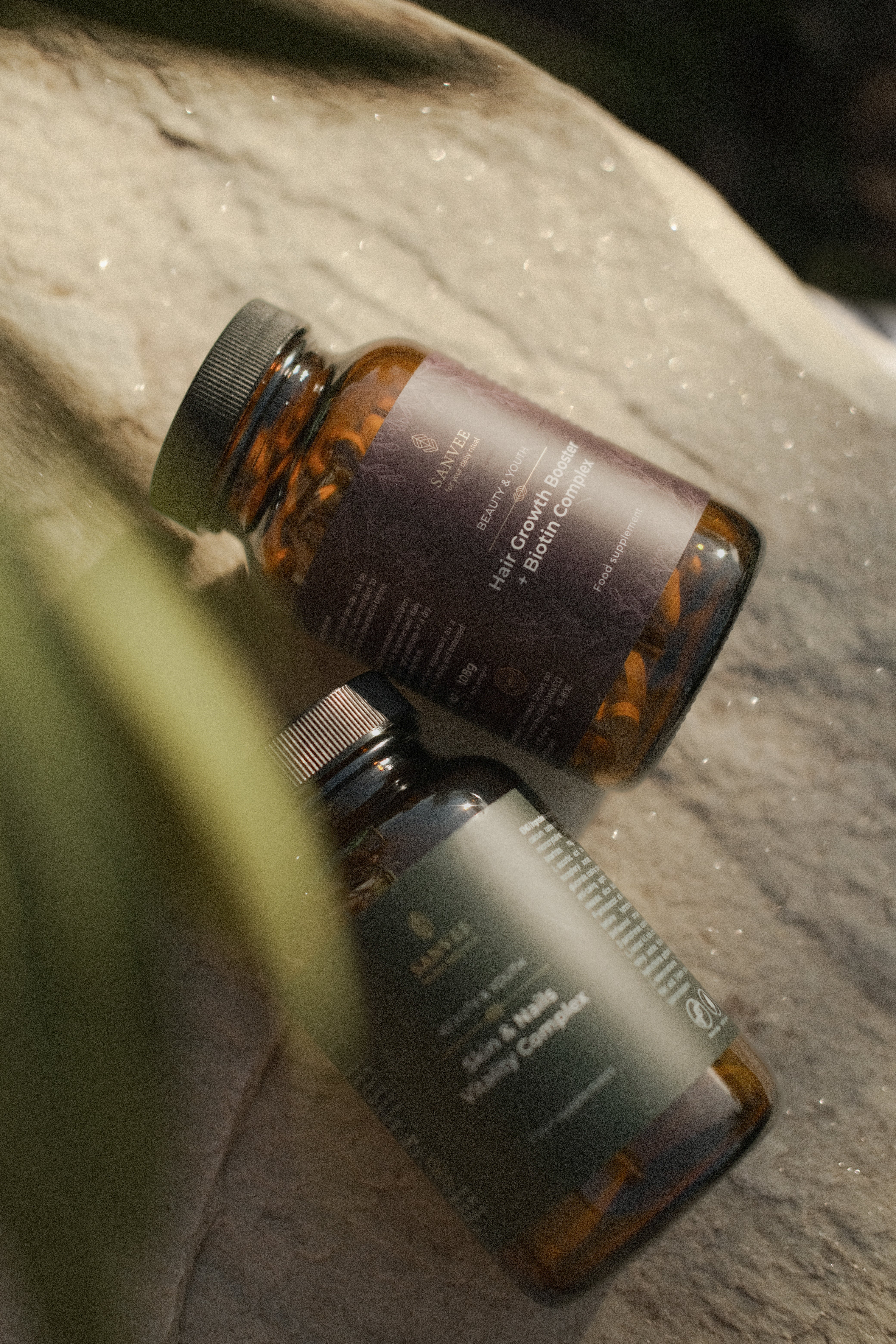 Sanvee hair growth booster with skin and nails complex capsules in glass bottle on natural stone
